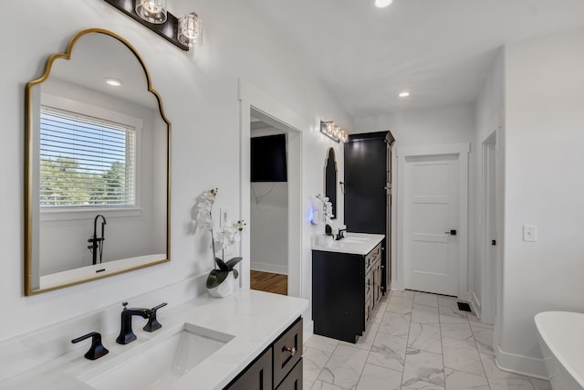 bathroom featuring a tub to relax in and vanity