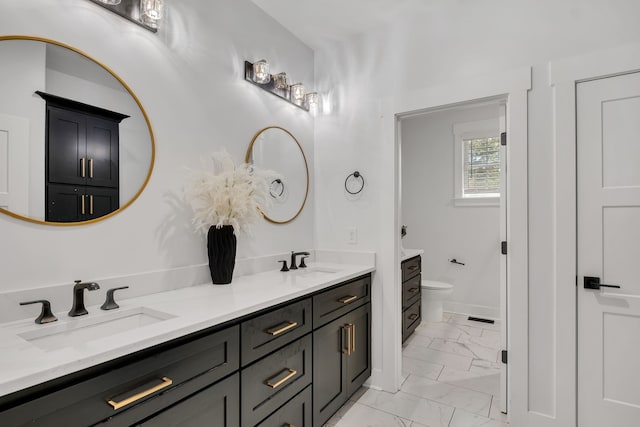 bathroom featuring toilet and vanity