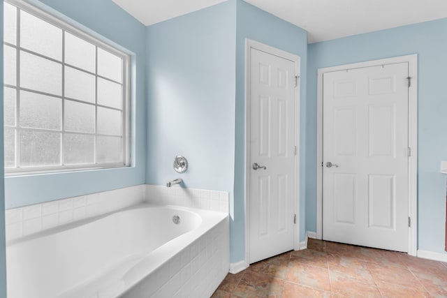 bathroom featuring tiled tub