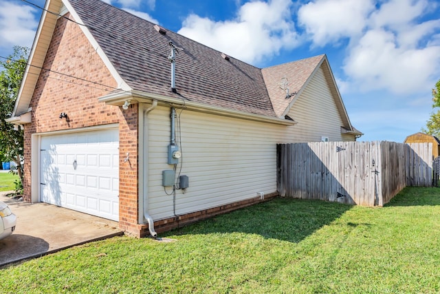 view of home's exterior featuring a lawn and a garage