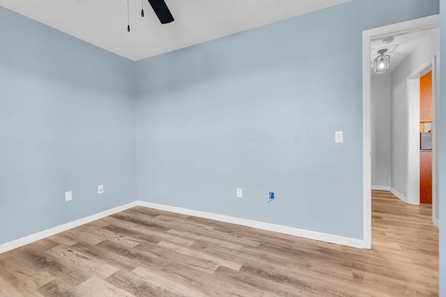 spare room featuring ceiling fan and hardwood / wood-style floors