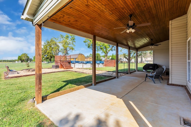 view of patio with ceiling fan and a covered pool