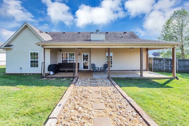 rear view of house featuring outdoor lounge area, a patio area, a lawn, and ceiling fan