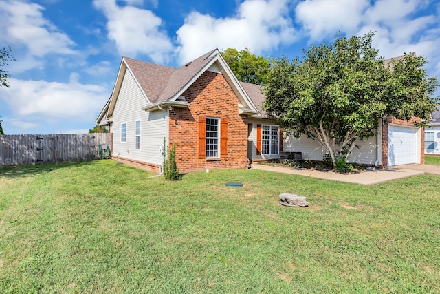 view of front of home with a front lawn and a garage