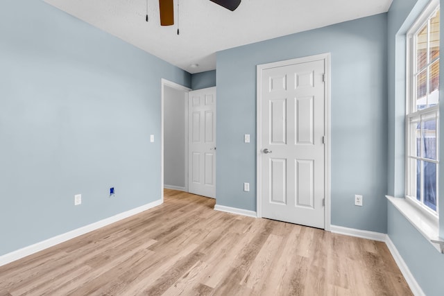 unfurnished bedroom with a textured ceiling, light hardwood / wood-style flooring, and ceiling fan