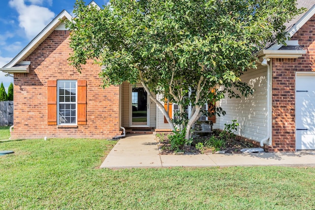 view of property hidden behind natural elements featuring a front yard