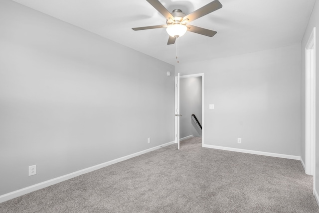 carpeted spare room with ceiling fan