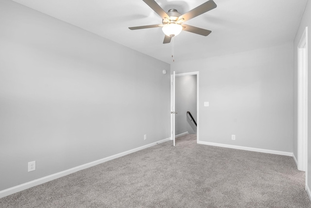 empty room with baseboards, carpet floors, and ceiling fan