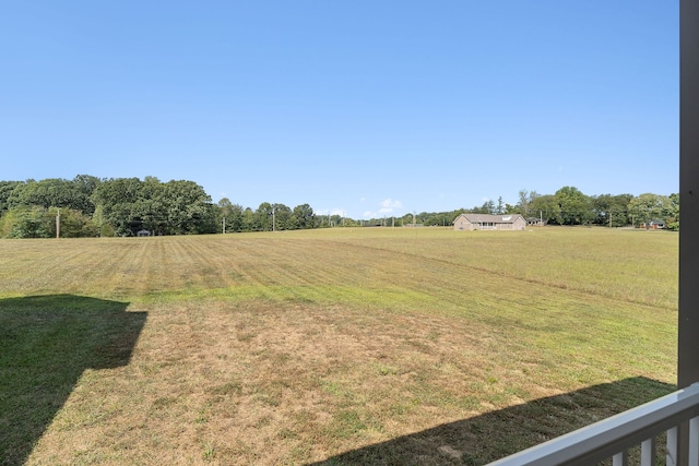 view of yard with a rural view