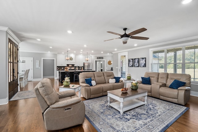 living room featuring crown molding, hardwood / wood-style flooring, and ceiling fan