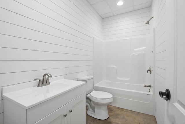 full bathroom with vanity, concrete floors, toilet,  shower combination, and wooden walls