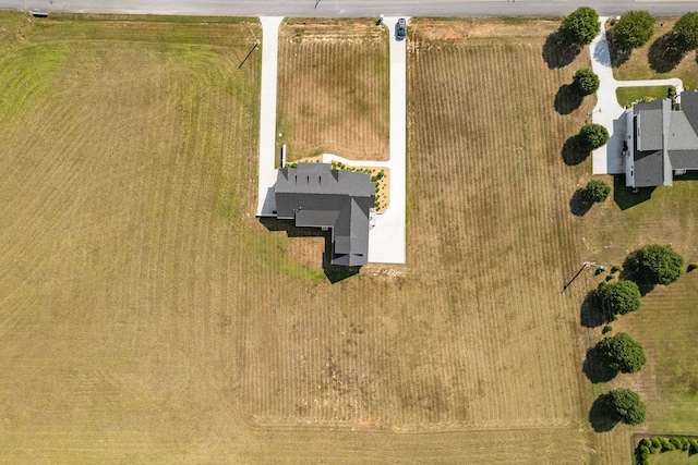 birds eye view of property with a rural view