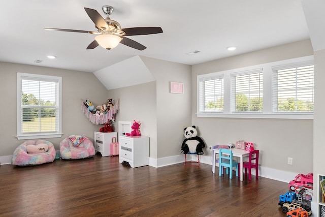 recreation room featuring plenty of natural light, ceiling fan, dark hardwood / wood-style floors, and vaulted ceiling