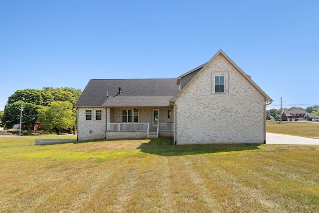 back of property featuring a porch and a lawn