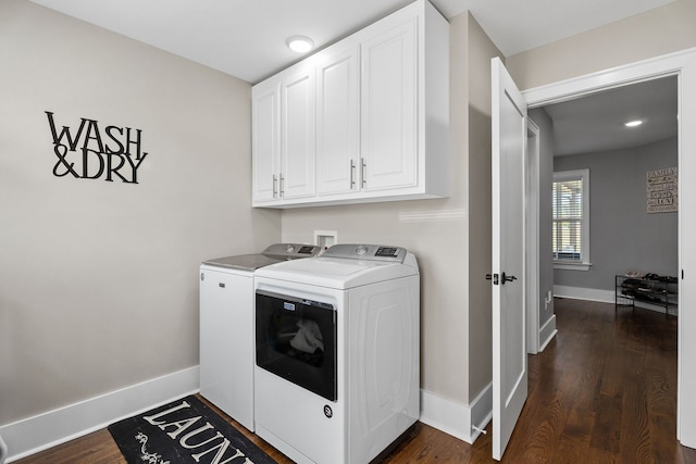 washroom featuring cabinets, independent washer and dryer, and dark hardwood / wood-style floors