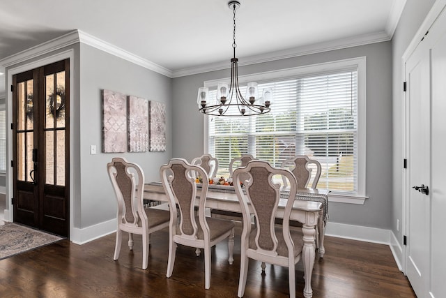 dining room featuring dark hardwood / wood-style floors, a chandelier, and crown molding