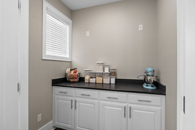 bar with white cabinetry