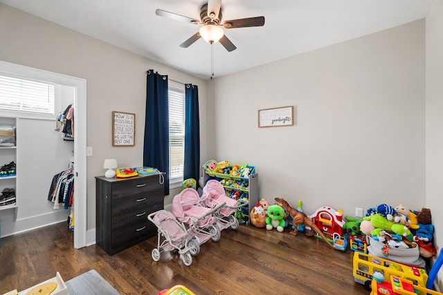 playroom with ceiling fan, plenty of natural light, and dark hardwood / wood-style floors