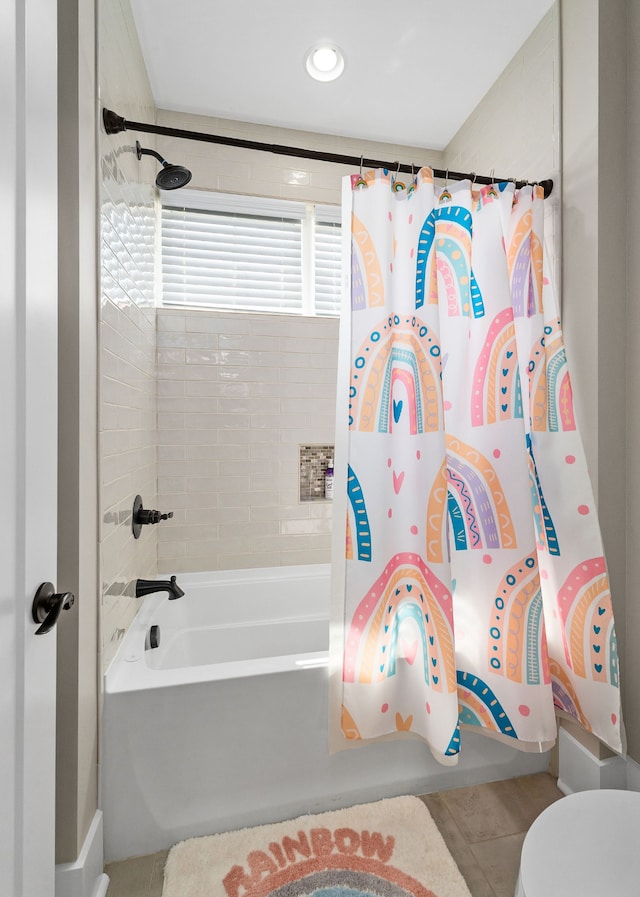 bathroom with toilet, tile patterned flooring, and shower / bath combo