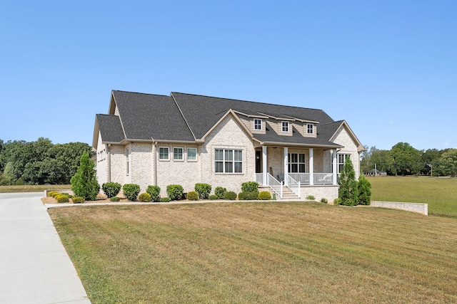 view of front facade with covered porch and a front yard