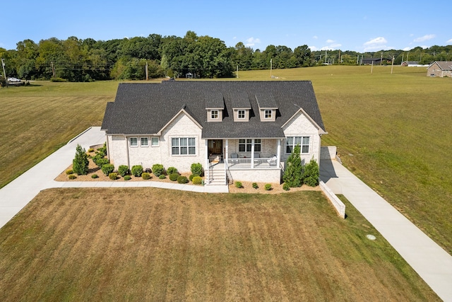 cape cod home featuring a front lawn and a porch