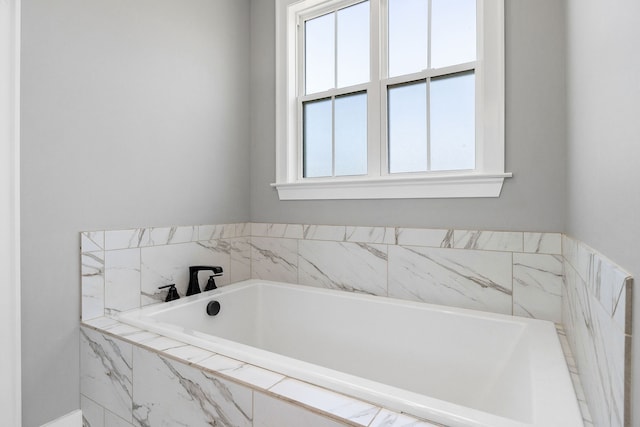 bathroom featuring tiled tub