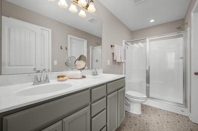 bathroom with vanity, toilet, tile patterned flooring, and a shower with door