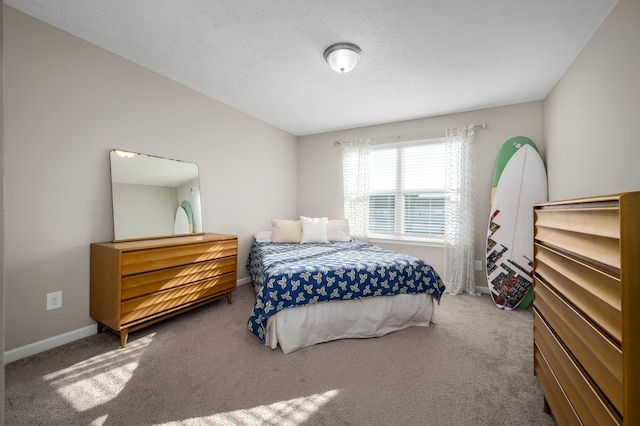 carpeted bedroom featuring a textured ceiling