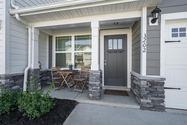 doorway to property featuring covered porch