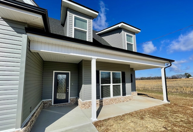 property entrance featuring a patio area