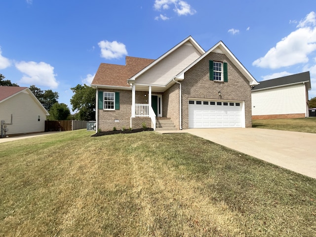 view of front of home featuring a garage, covered porch, and a front yard