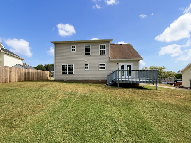 back of house featuring a yard and a deck