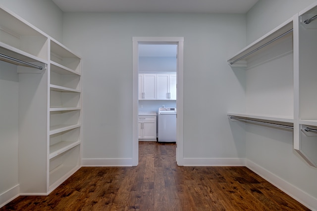 walk in closet featuring dark wood-type flooring and washer / dryer