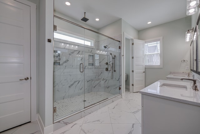 bathroom featuring an enclosed shower, vanity, and toilet