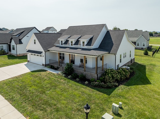 view of front of property featuring central AC, a front yard, a porch, and a garage