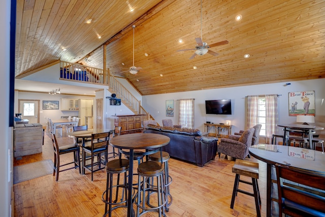 living room featuring plenty of natural light, ceiling fan, wooden ceiling, and light wood-type flooring