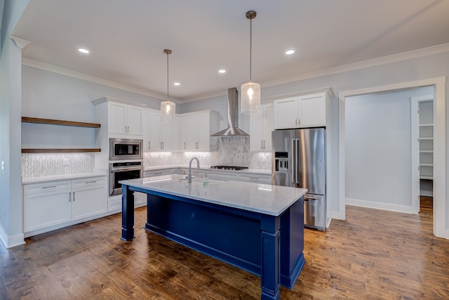 kitchen with white cabinets, appliances with stainless steel finishes, wall chimney exhaust hood, and dark hardwood / wood-style floors