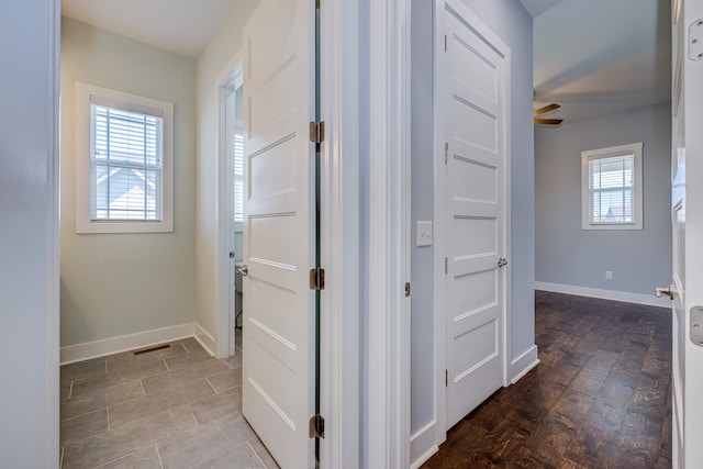 hall with wood-type flooring and plenty of natural light