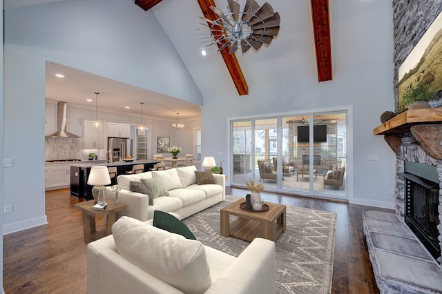 living room featuring ceiling fan, a fireplace, dark wood-type flooring, and high vaulted ceiling