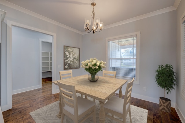 dining space featuring ornamental molding, a chandelier, and dark wood-type flooring