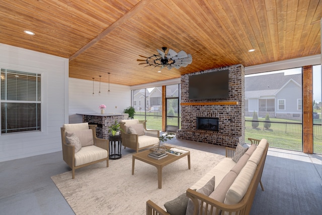 living room with wooden ceiling, concrete floors, a fireplace, and ceiling fan