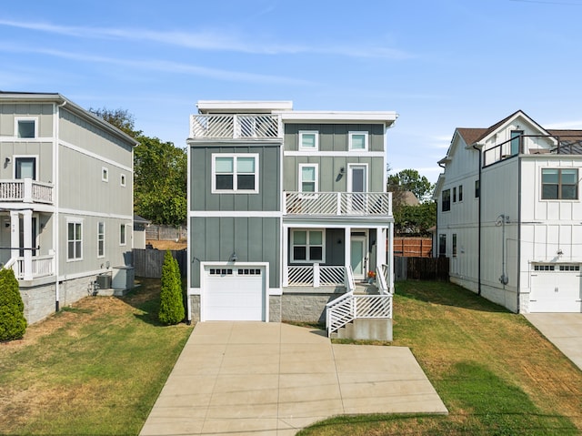 view of front of house featuring a garage, a front lawn, and a balcony