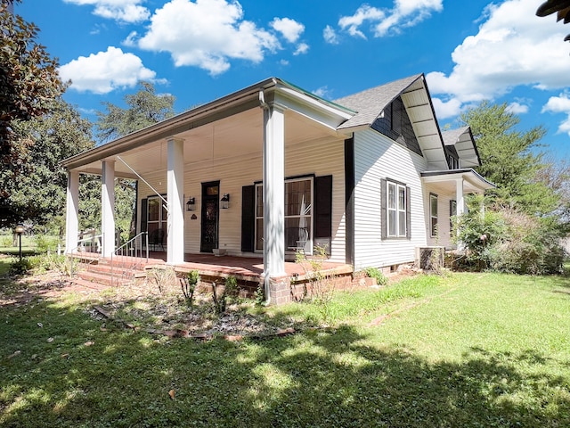 view of home's exterior featuring a yard and covered porch