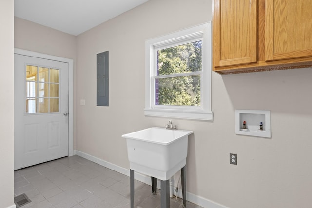 laundry area with baseboards, washer hookup, electric panel, light tile patterned flooring, and cabinet space