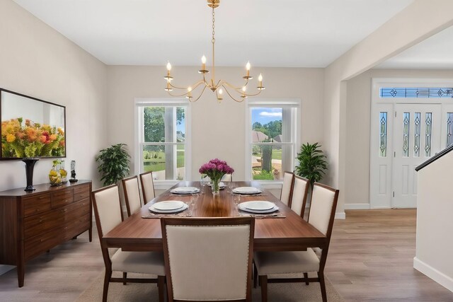 dining room with a chandelier and light hardwood / wood-style floors