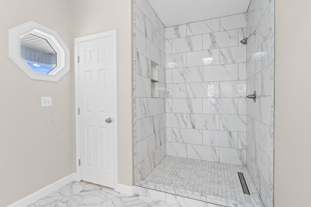 bathroom with a tile shower