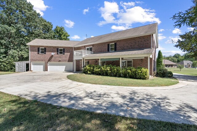 view of front of property with a garage and a front yard