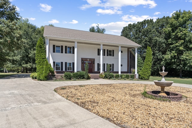 greek revival house featuring a porch