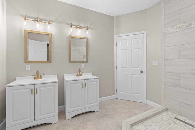 bathroom with tile patterned floors, two vanities, baseboards, and a sink