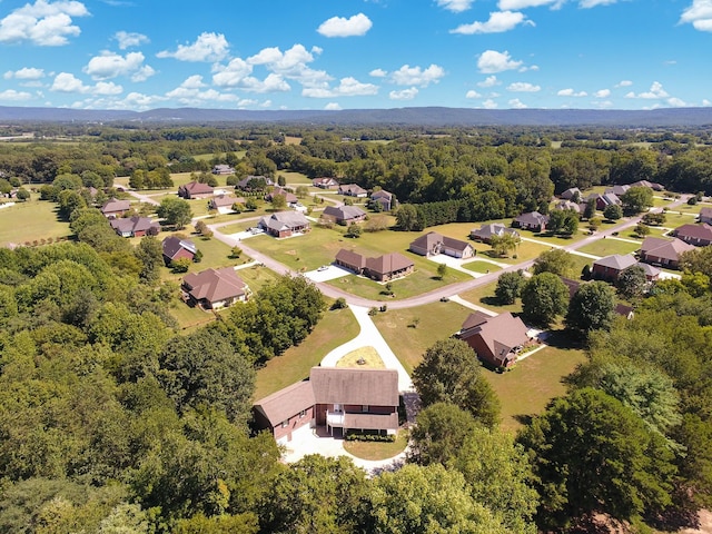 aerial view featuring a residential view and a wooded view